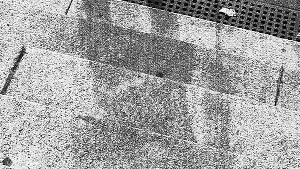 The shadow of the Hiroshima resident seated on the Sumitomo bank steps.